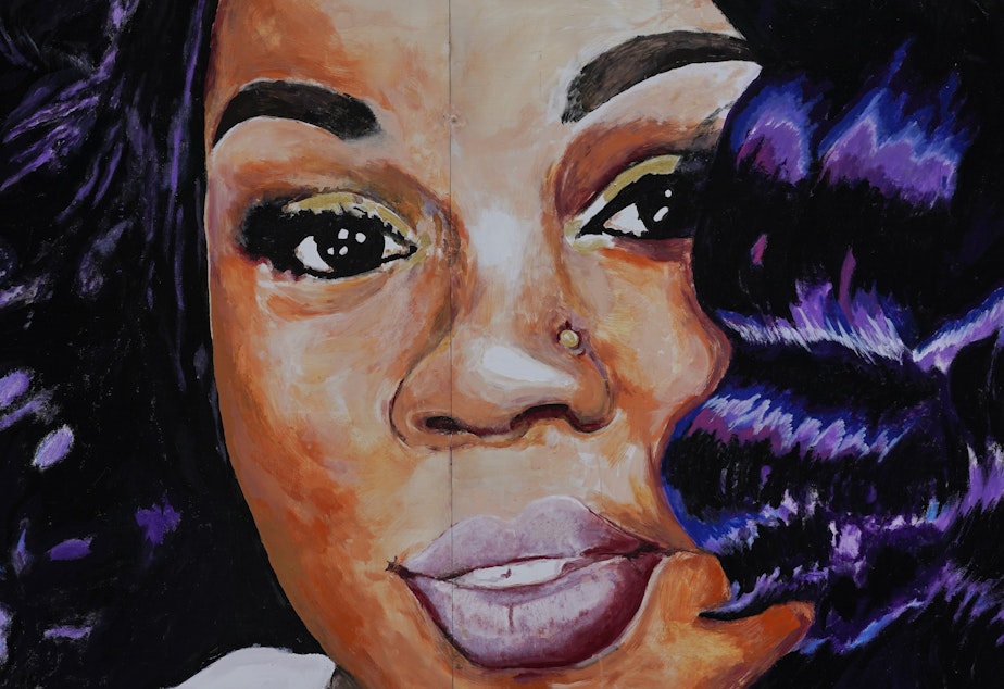 caption: A mural of Breonna Taylor in Louisville, Ky. Prosecutors have reached an agreement with Jamarcus Glover, the ex-boyfriend police arrested the night they killed Taylor.