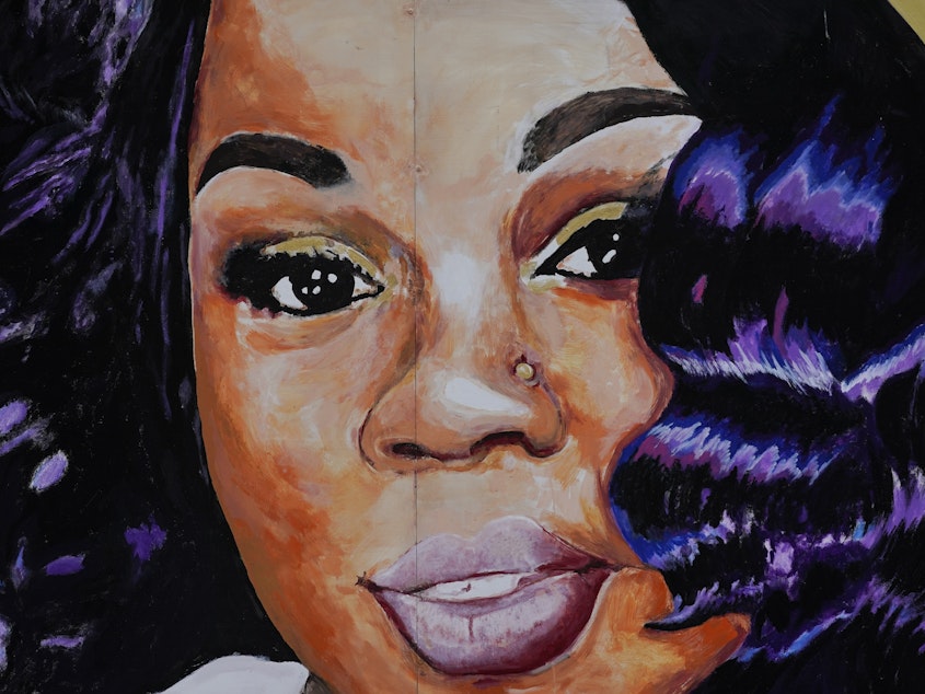 caption: A mural of Breonna Taylor in Louisville, Ky. Prosecutors have reached an agreement with Jamarcus Glover, the ex-boyfriend police arrested the night they killed Taylor.