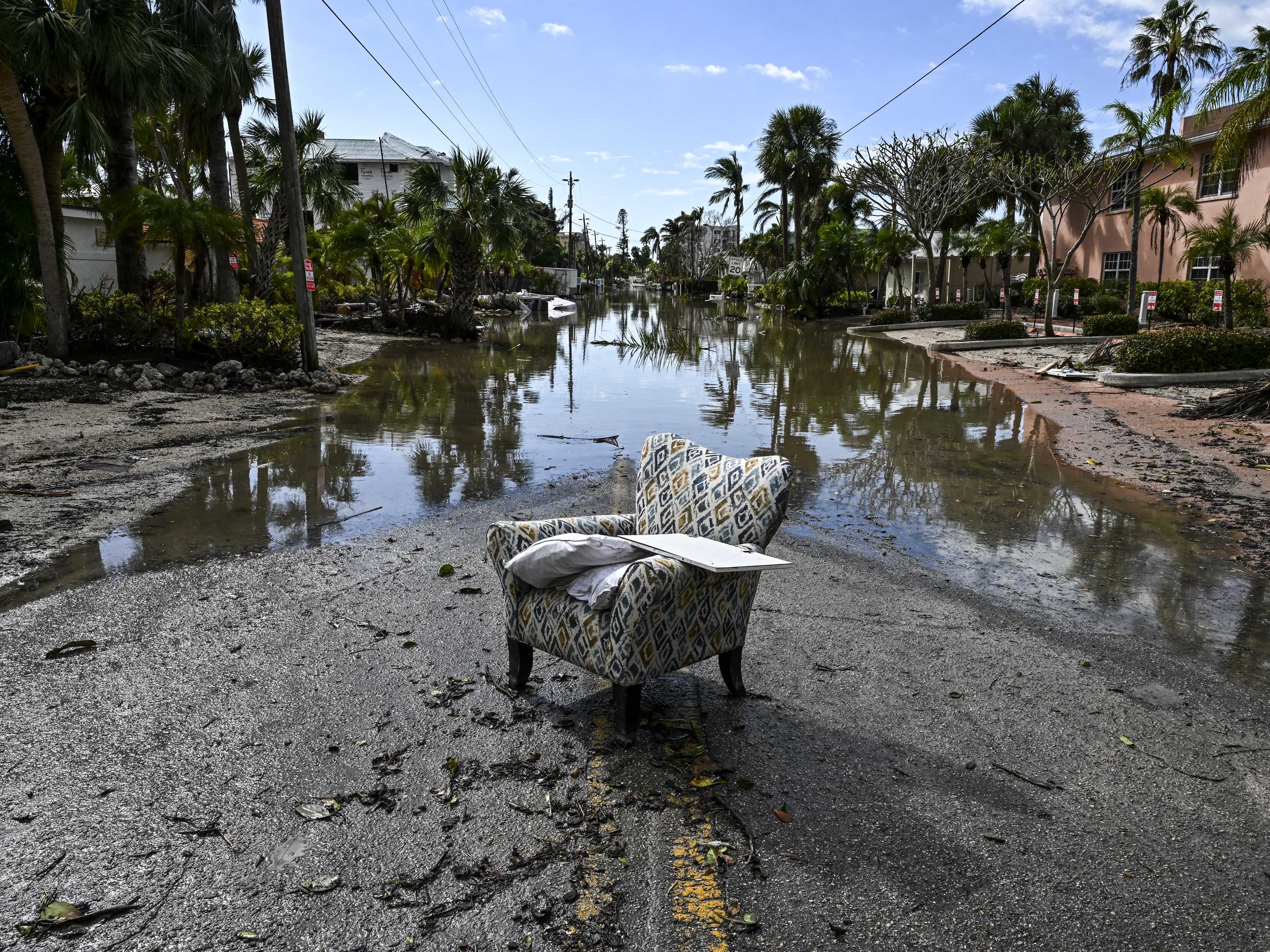 caption: A flooded street with debris in the aftermath of Hurricane Milton, in Siesta Key, Fla., on October 10, 2024. The monster weather system sent tornadoes spinning across the state and flooded swaths of the Tampa Bay area after the storm rapidly intensified to a top-of-scale category 5 major hurricane.