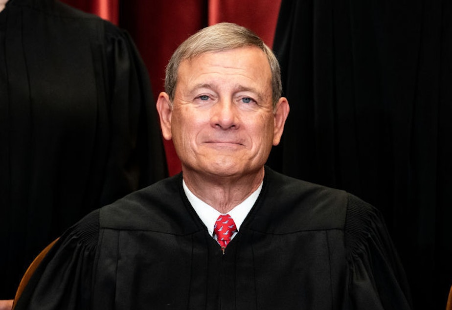 caption: Chief Justice John Roberts sits during a group photo of the Justices at the Supreme Court in 2021.