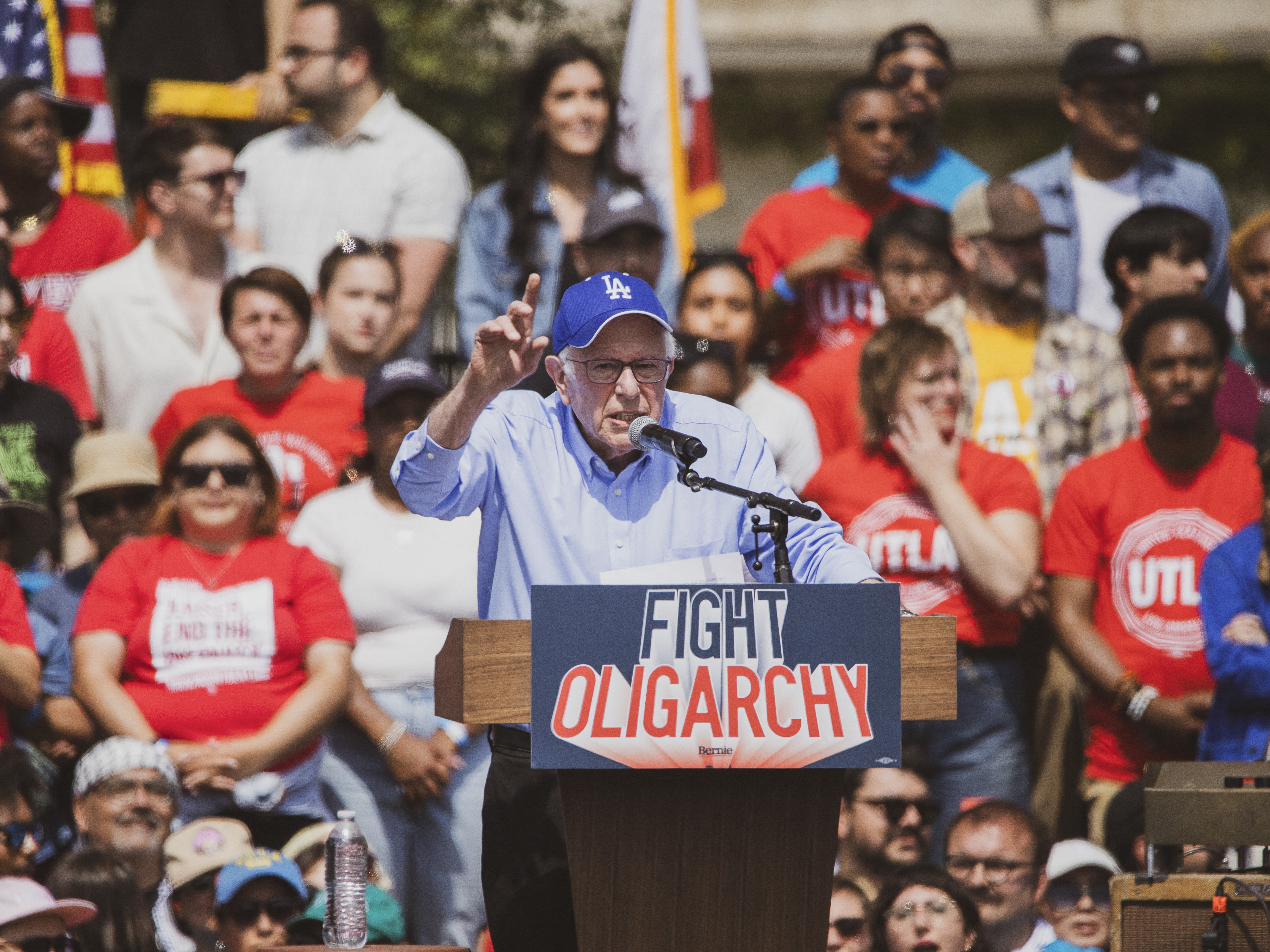 caption: Sen. Bernie Sanders Speaks To A Crowd Of 36,000 At The Fighting Oligarchy Rally At Gloria Molina Grand Park In Downtown Los Angeles On April 12, 2025.