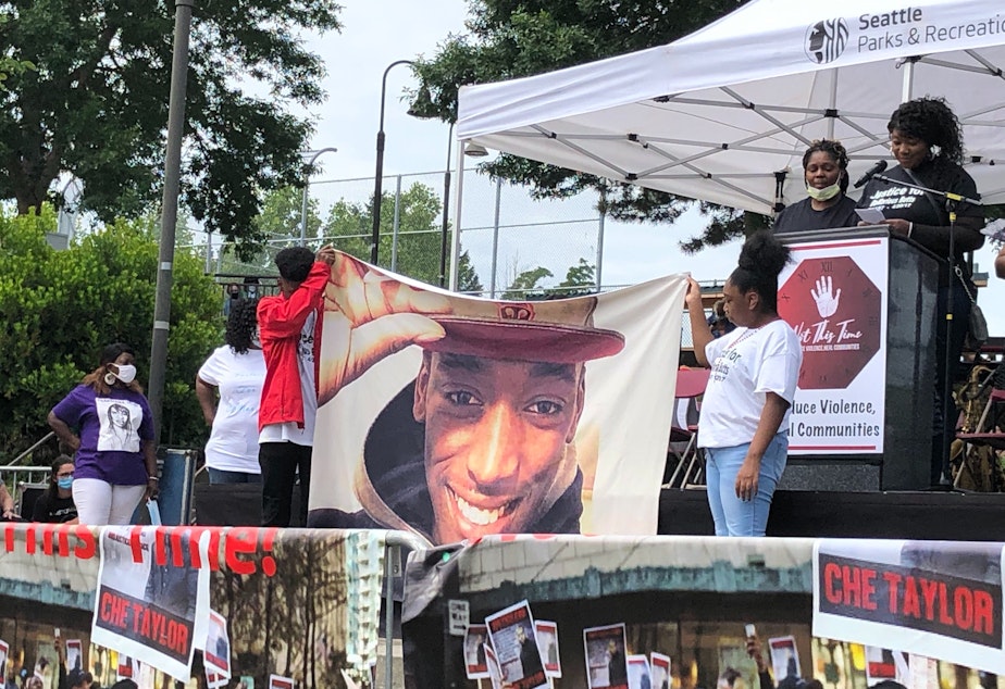 caption: Stephanie Butts, at the microphone, remembers her son Damarius Butts, as his siblings hold up his photo. The inquest into the facts of his death was King County's first in almost five years. 