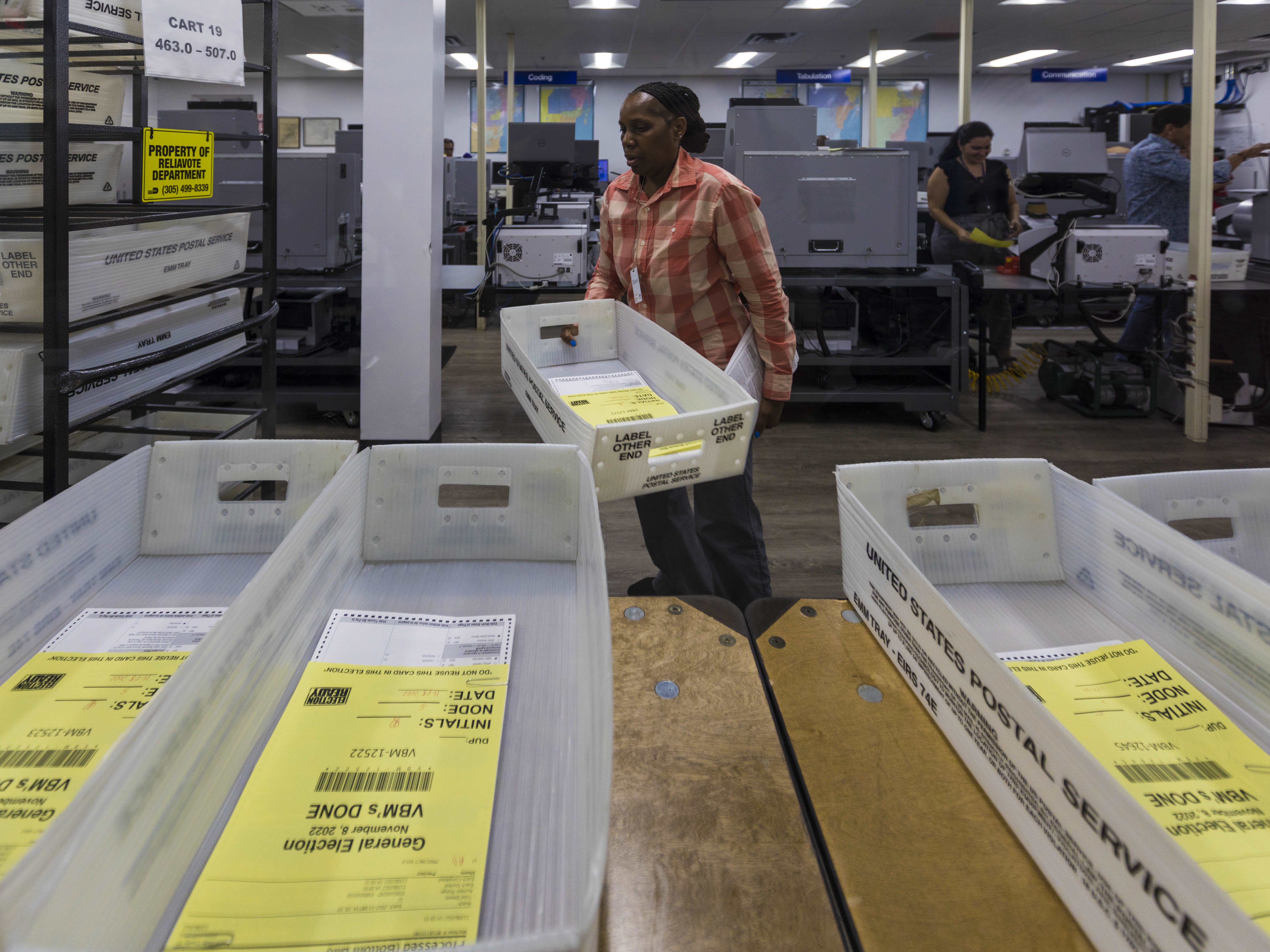 caption: Miami-Dade County elections workers begin counting Florida mail ballots on Nov. 8, 2022.