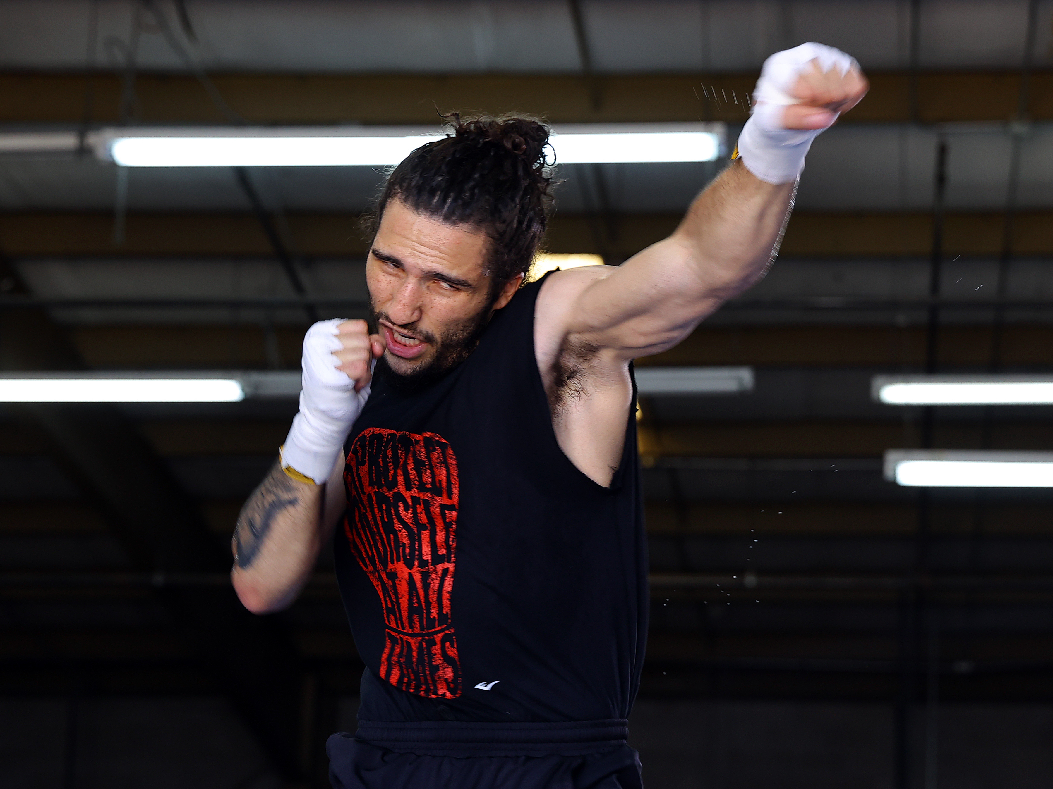 caption: Middleweight prospect Nico Ali Walsh, grandson of "The Greatest," Muhammad Ali, trains in Las Vegas with head coach Sugar Hill Steward earlier this month, ahead of his pro debut in Oklahoma.