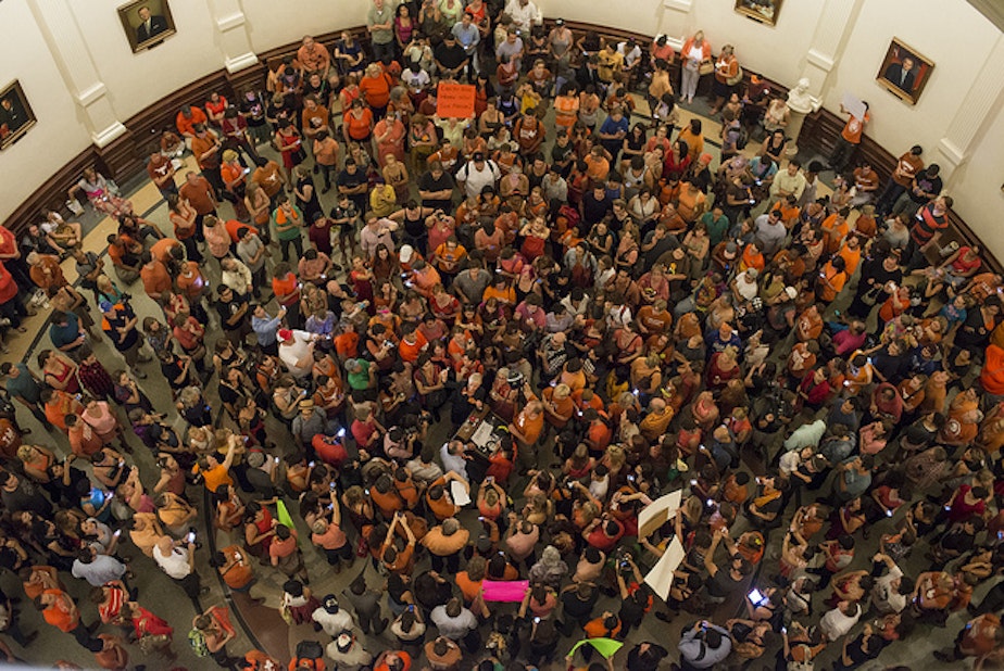 caption: Earlier this year, people protesting restrictive abortion laws in Texas staged a sit-in at the state capitol. The bill passed, but key portions were blocked by a recent court ruling.
