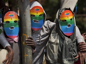 caption: Kenyan gays and lesbians and others supporting their cause wear masks to preserve their anonymity as they stage a rare protest against Uganda's tough stance against homosexuality and in solidarity with their counterparts there, outside the Uganda High Commission in Nairobi, Kenya, in 2014.