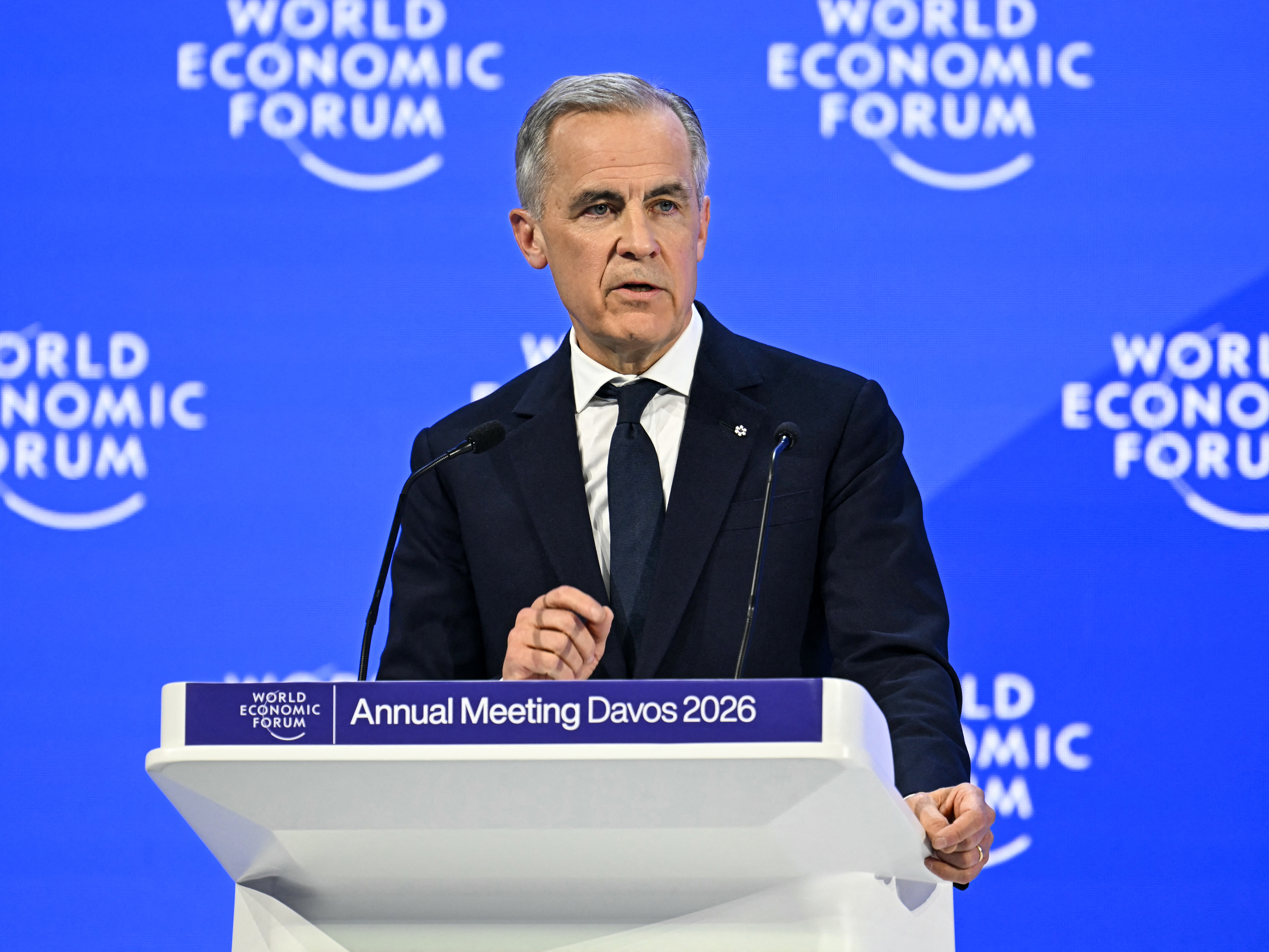caption: Canada's Prime Minister Mark Carney delivers a speech during the World Economic Forum (WEF) annual meeting in Davos on January 20, 2026.