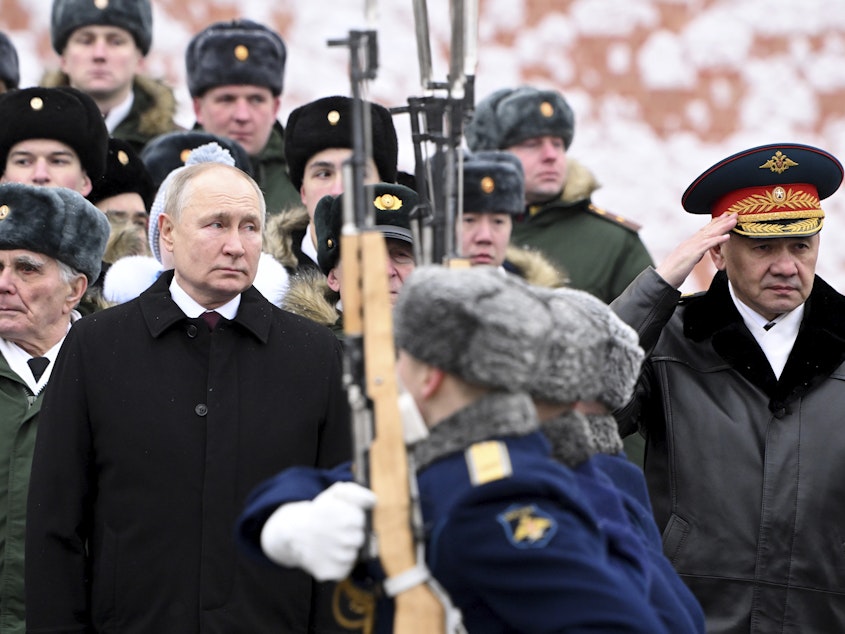 caption: Russian President Vladimir Putin and Defense Minister Sergei Shoigu (right) take part in a wreath-laying ceremony at the Tomb of the Unknown Soldier in Alexander Garden on Defender of the Fatherland Day, in Moscow, Friday.