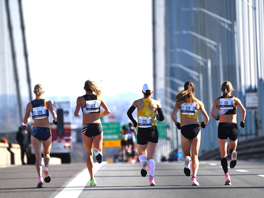 caption: A group of runners compete in the New York City Marathon in 2019. It's one of many big city races to return this year after they were cancelled over pandemic health restrictions in 2020.