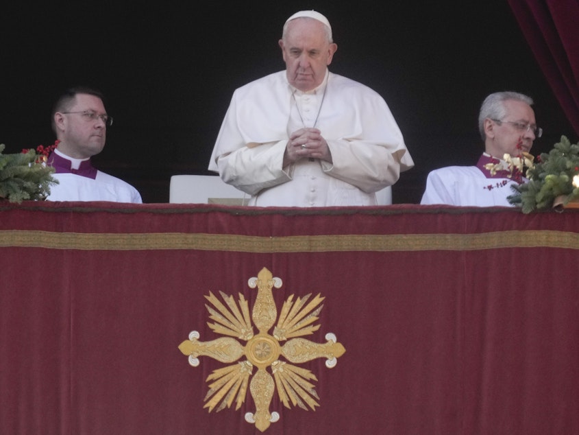 caption: Pope Francis delivers the Urbi et Orbi (Latin for 'to the city and to the world') Christmas day blessing from the main balcony of St. Peter's Basilica at the Vatican on Sunday.