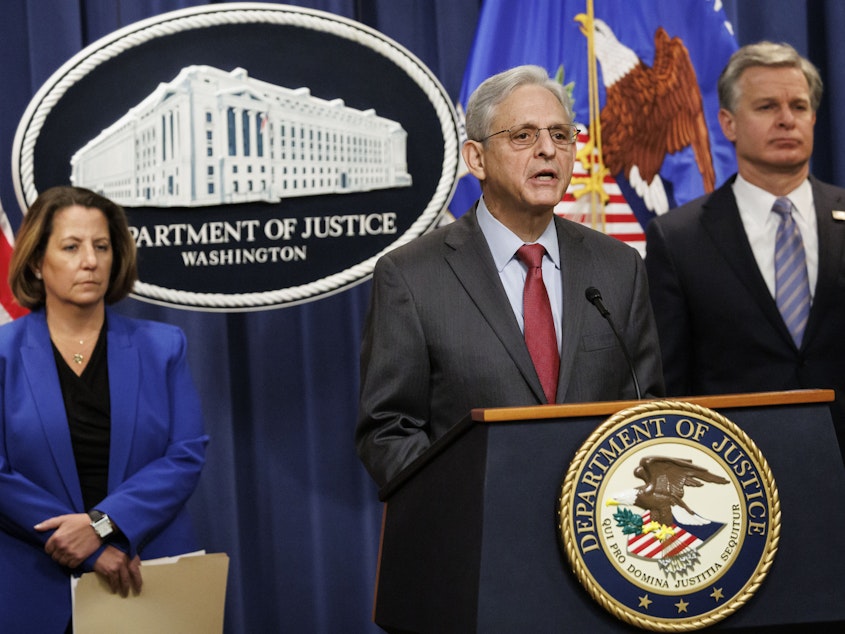 caption: U.S. Attorney General Merrick Garland speaks during a news conference with Deputy Attorney General Lisa Monaco (left), and FBI Director Christopher Wray at the Department of Justice in Washington on Thursday.