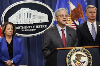 caption: U.S. Attorney General Merrick Garland speaks during a news conference with Deputy Attorney General Lisa Monaco (left), and FBI Director Christopher Wray at the Department of Justice in Washington on Thursday.