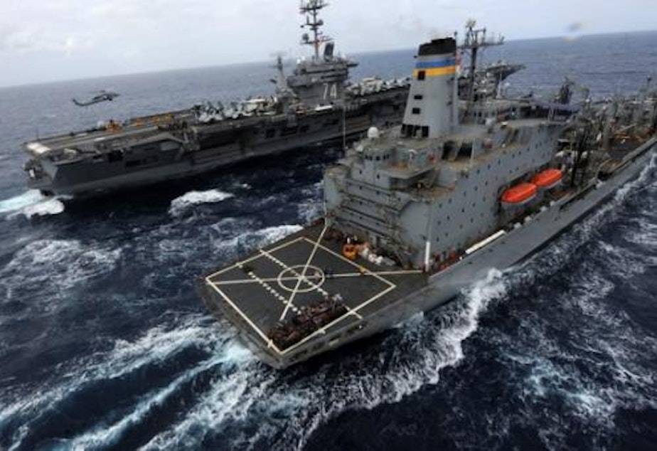 The U.S. Navy's aircraft carrier USS John C. Stennis transits the Pacific Ocean alongside the oiler USNS Yukon.