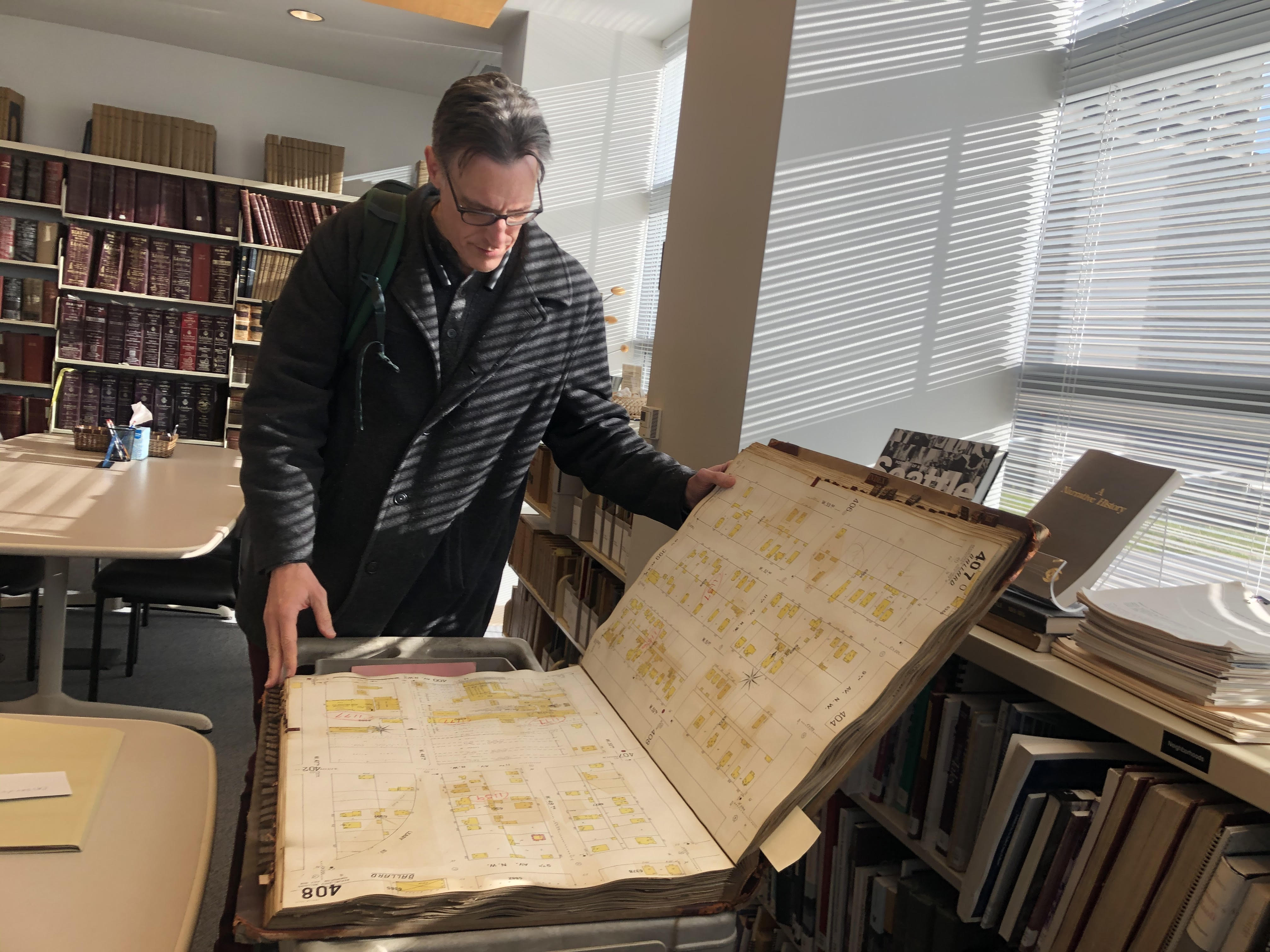 caption: Bill Radke looking through archives