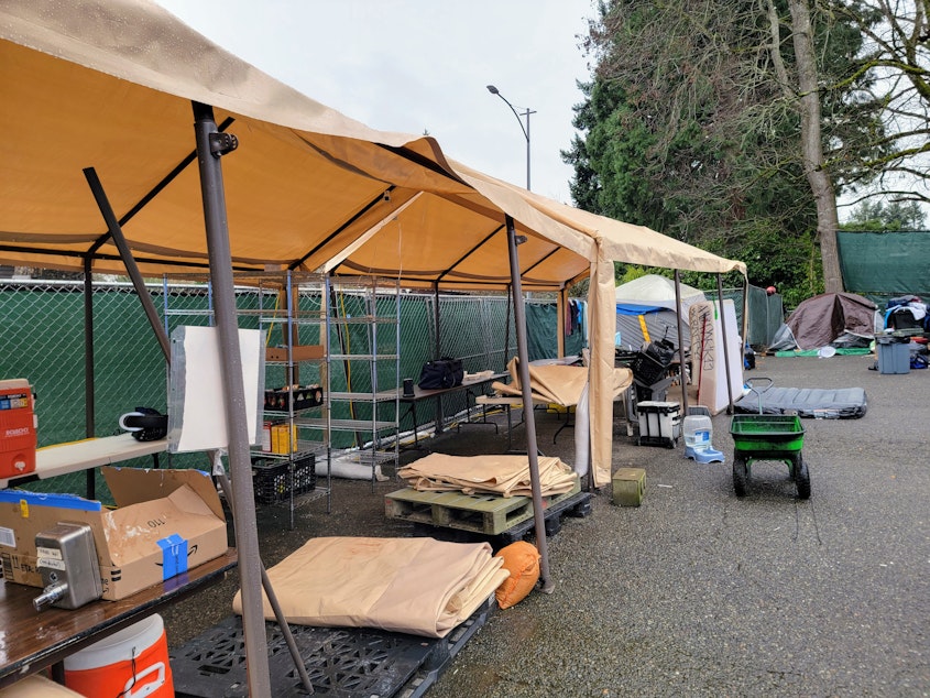 caption: Volunteers dismantle the Sunnydale Village kitchen and supply tents on Monday, Feb. 6, 2024.