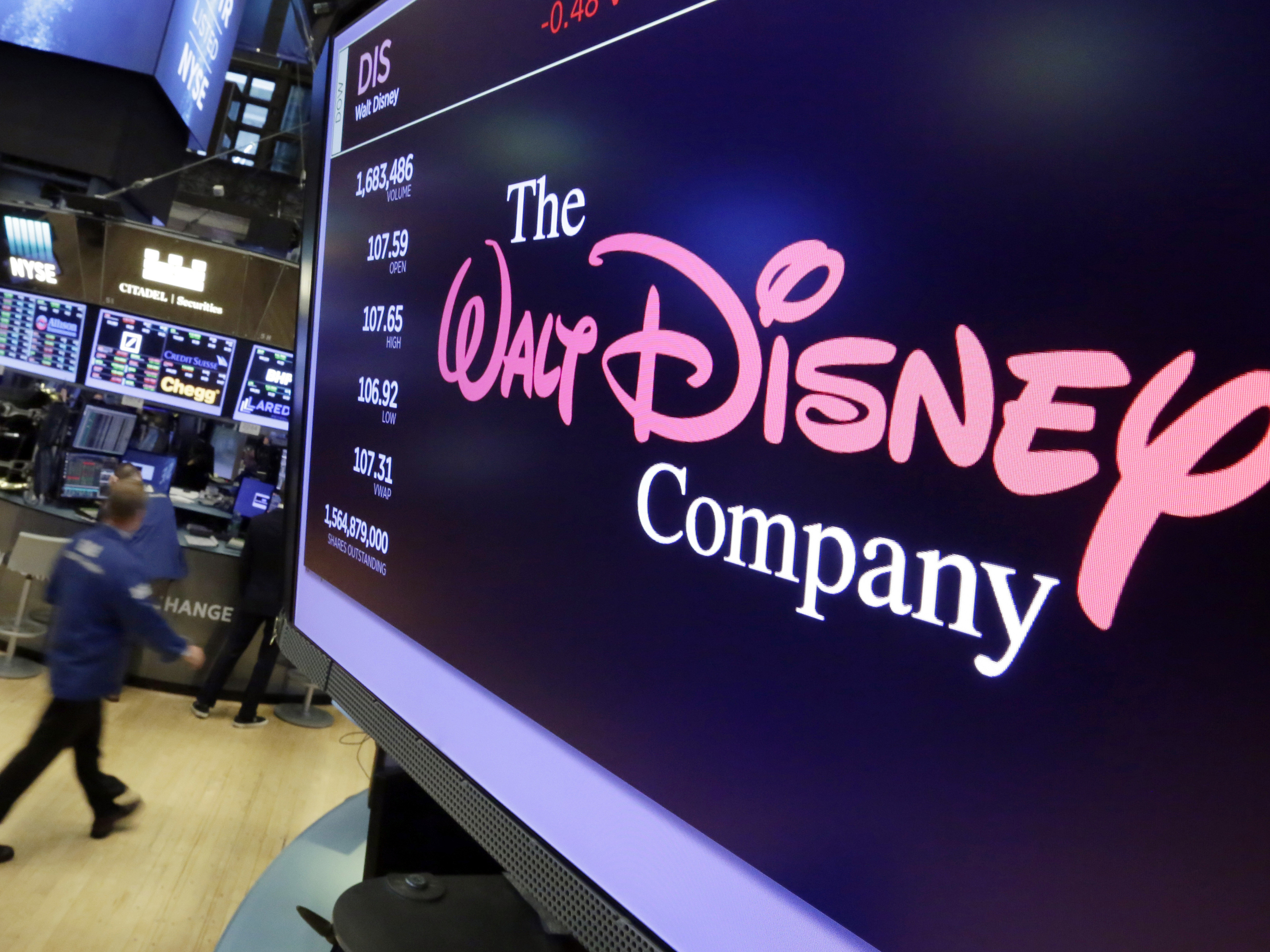 caption: The Walt Disney Co. logo appears on a screen above the floor of the New York Stock Exchange on Aug. 8, 2017, in New York.