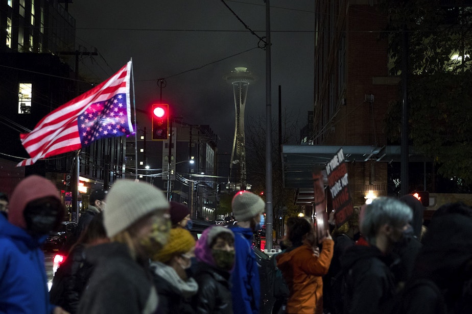 caption: Protesters with multiple groups march together for racial justice and against police brutality through the South Lake Union neighborhood on the night of the 2020 presidential election, on Tuesday, November 3, 2020, in Seattle. Organizers made clear that despite the outcome of the election, protests for racial justice will continue.