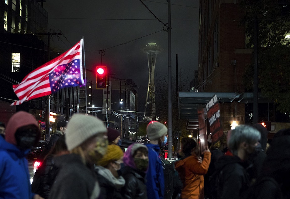 caption: Protesters with multiple groups march together for racial justice and against police brutality through the South Lake Union neighborhood on the night of the 2020 presidential election, on Tuesday, November 3, 2020, in Seattle. Organizers made clear that despite the outcome of the election, protests for racial justice will continue. 