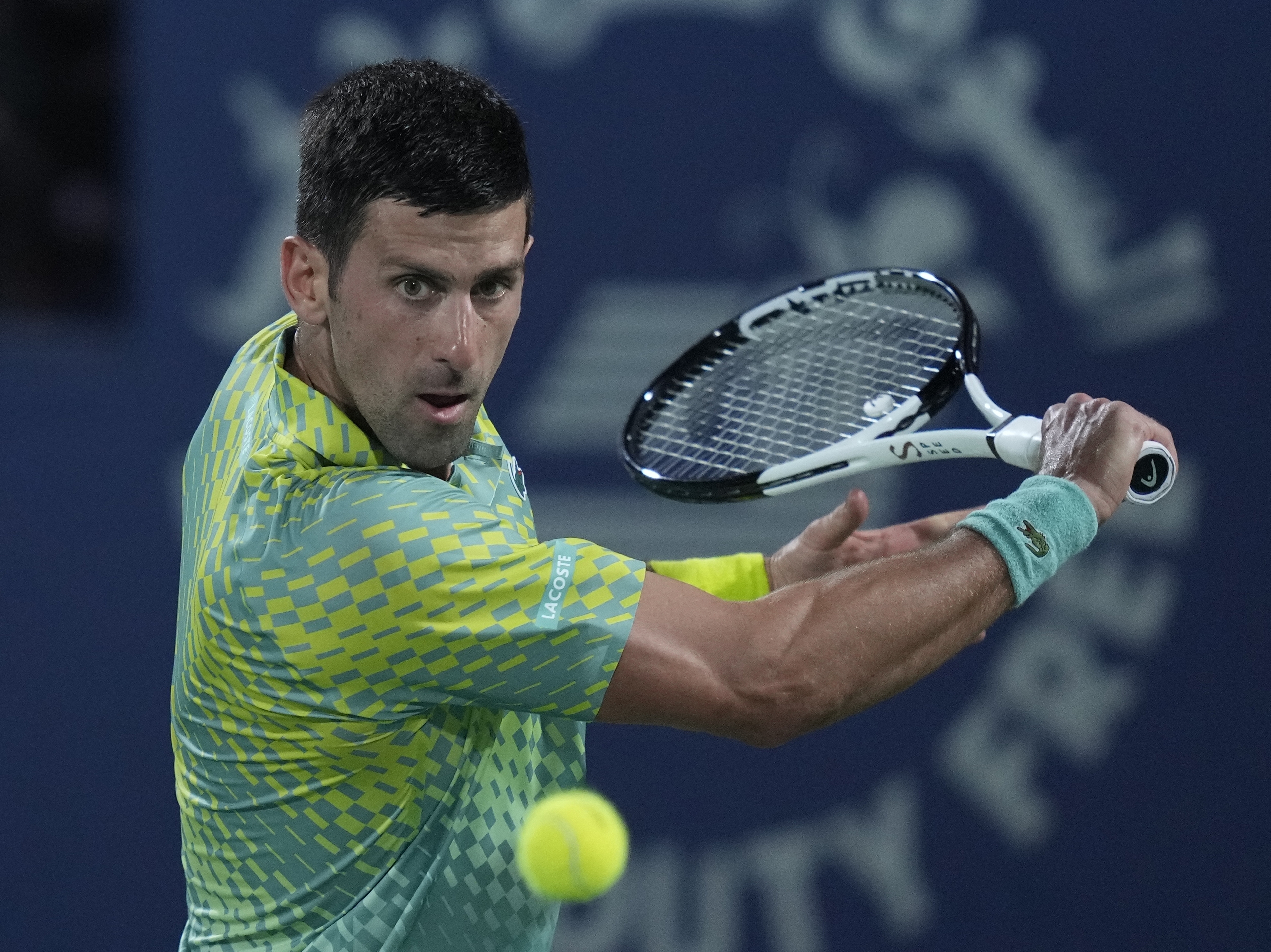 caption: Serbia's Novak Djokovic returns the ball to Daniil Medvedev during their semi final match of the Dubai Duty Free Tennis Championships in Dubai, United Arab Emirates, on March 2.