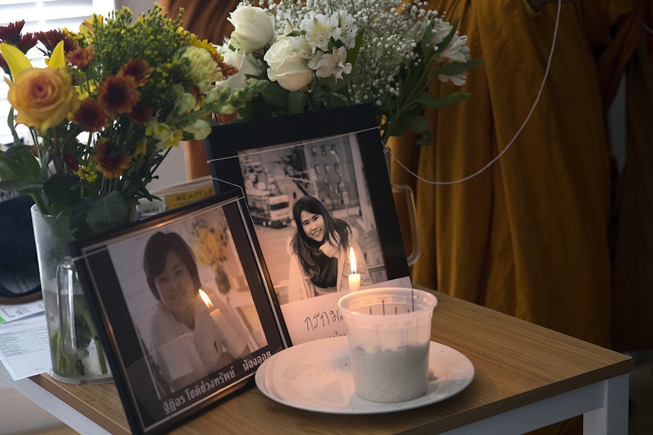 caption: Framed pictures of Thiti-on Chotechuangsab, 32, left, and Kornkamon Leenawarat, 25, right, are shown during a dedication ceremony with the Buddhangkura Buddhist Temple of Washington, in the apartment where the two women lived, on Wednesday, September 12, 2018, in Seattle. 