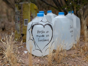 caption: Jugs of water for undocumented immigrants sit along migrant trails after being delivered by volunteers for the humanitarian aid group No More Deaths. The number of immigrant deaths, mostly due to dehydration and exposure, has risen as higher border security has pushed immigrant crossing routes into more remote desert regions.