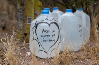 caption: Jugs of water for undocumented immigrants sit along migrant trails after being delivered by volunteers for the humanitarian aid group No More Deaths. The number of immigrant deaths, mostly due to dehydration and exposure, has risen as higher border security has pushed immigrant crossing routes into more remote desert regions.