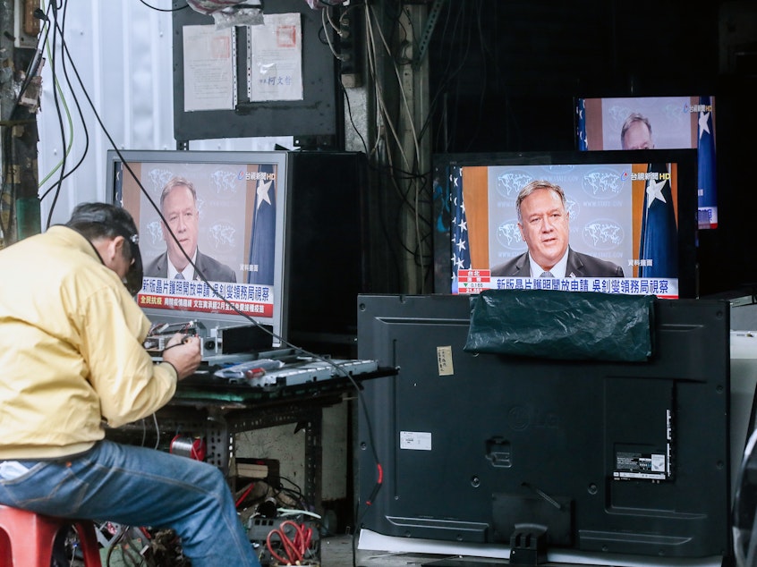 caption: Televisions show a news broadcast of U.S. Secretary of State Mike Pompeo in Taipei, Taiwan, on Jan. 11. The Trump administration removed decades-old restrictions on interactions with Taiwanese officials just days before President-elect Joe Biden's inauguration.