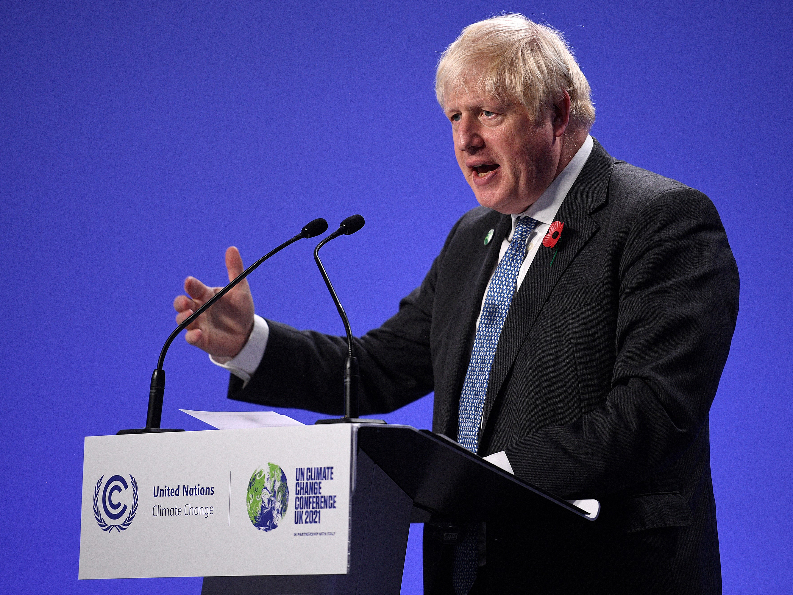 caption: British Prime Minister Boris Johnson speaks during a news conference at the U.N. Climate Change Conference COP26 in Glasgow, Scotland, on Tuesday.