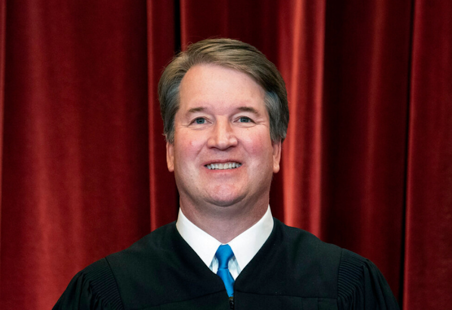 caption: Associate Justice Brett Kavanaugh stands during a group photo at the Supreme Court in Washington, on April 23, 2021. 