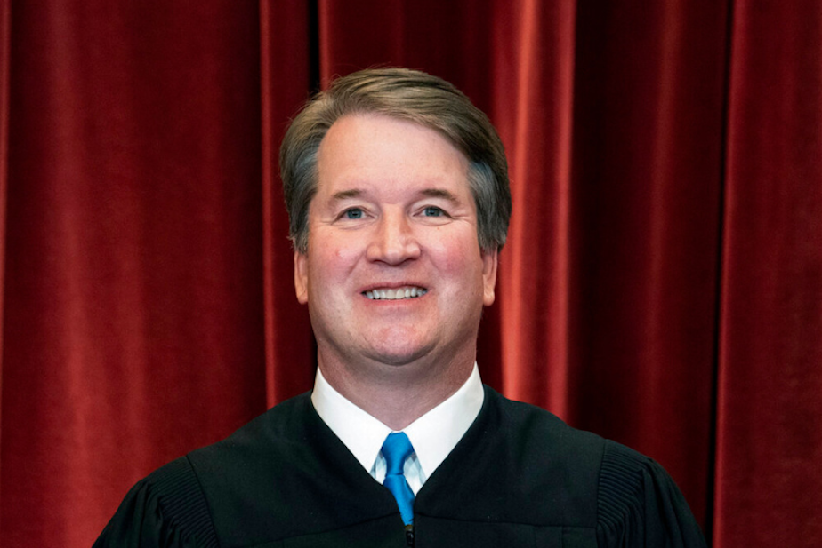 caption: Associate Justice Brett Kavanaugh stands during a group photo at the Supreme Court in Washington, on April 23, 2021. 