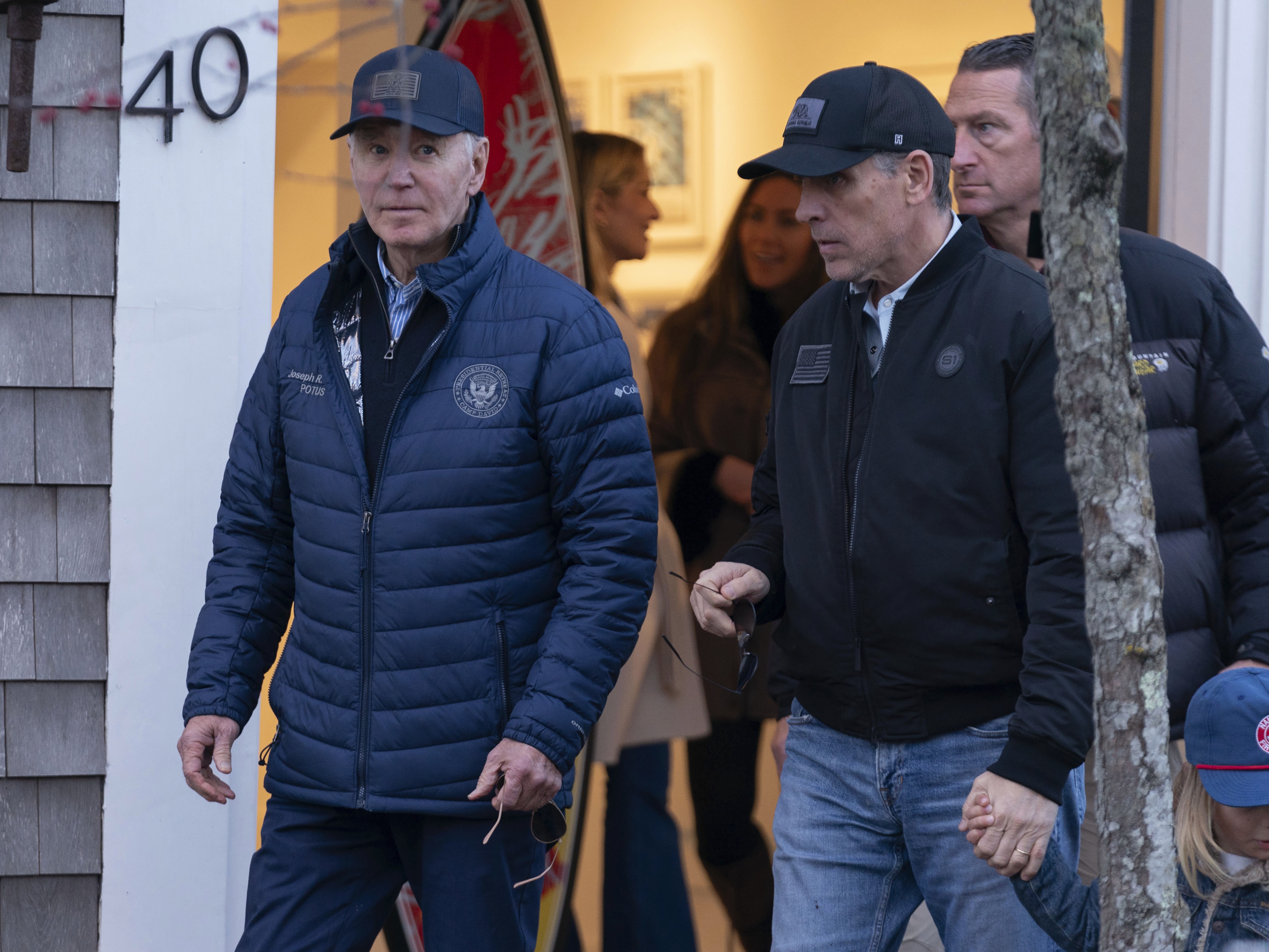 caption: President Biden and his son Hunter Biden walk in downtown Nantucket, Mass., on Friday.