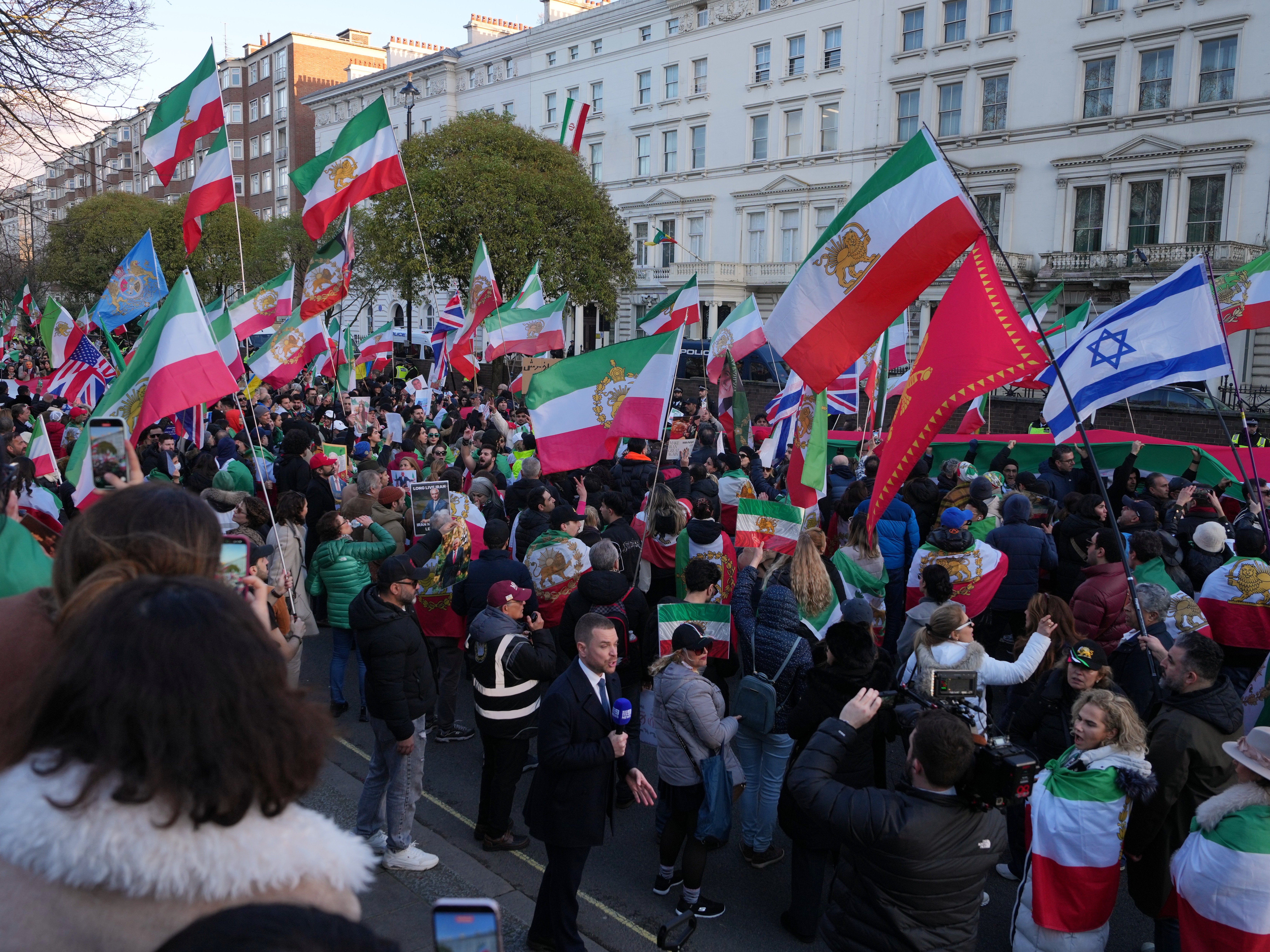 caption: Protesters gather in London, Saturday, Feb. 28, 2026 after U.S. and Israeli forces carried out a series of strikes on Iran on Saturday morning. (AP Photo/Alastair Grant)