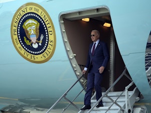 caption: President Joe Biden arrives at San Francisco International Airport for the APEC summit on Tuesday.