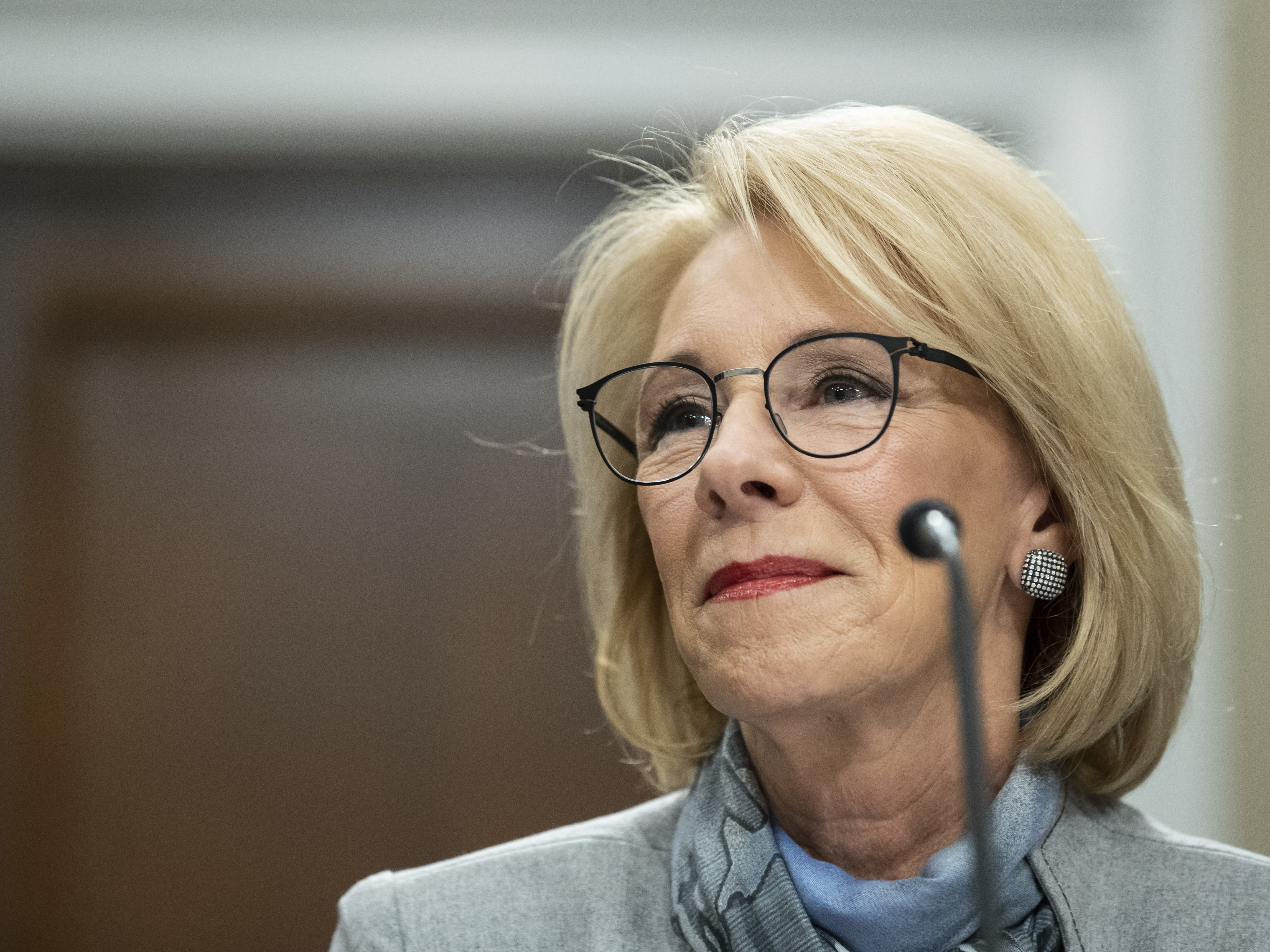 caption: U.S. Education Secretary Betsy DeVos, pictured here at a February Capitol Hill hearing, has long championed alternatives to public schools.
