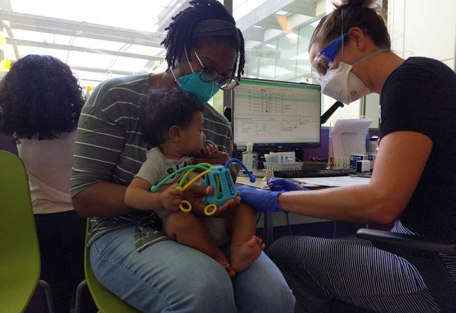 caption: Sandino, eight months old, gets his first shot of the Covid-19 vaccine at Seattle Children's on June 21, 2022.