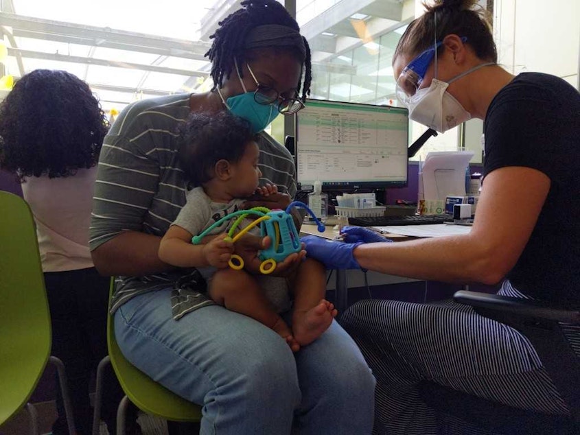 caption: Sandino, eight months old, gets his first shot of the Covid-19 vaccine at Seattle Children's on June 21, 2022.