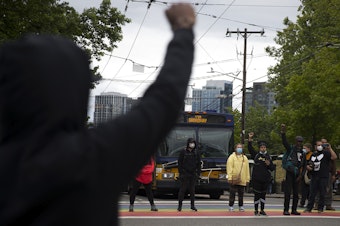 caption: Protesters form a circle and block traffic at the intersection of Broadway and East Pine Street after the Seattle Police Department cleared the Capitol Hill Organized Protest zone, CHOP, early Wednesday, July 1, 2020, in Seattle. 