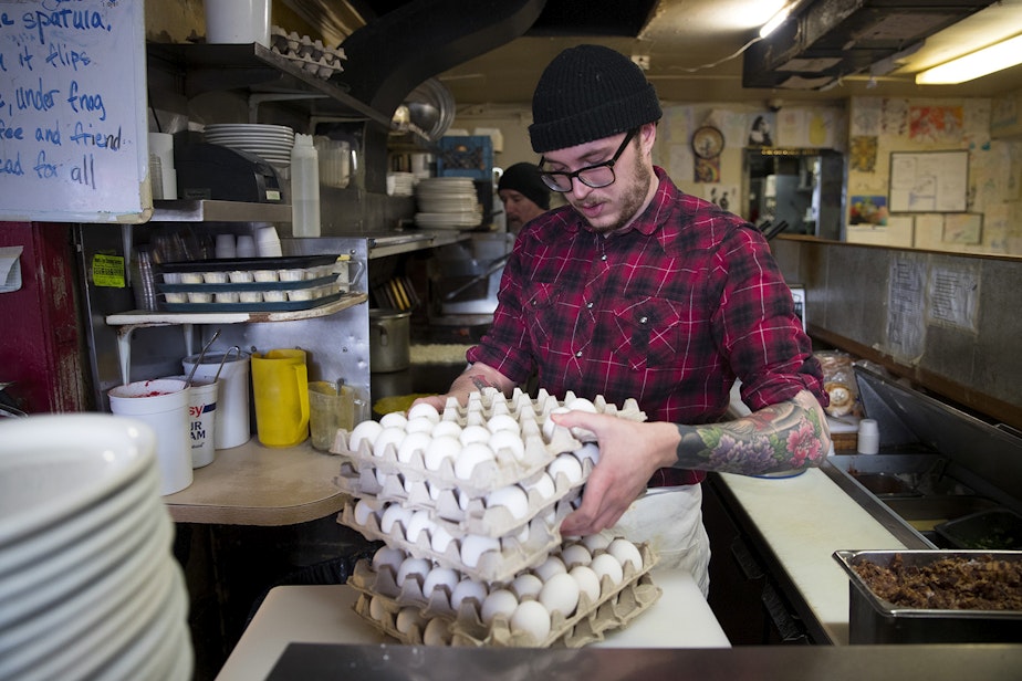 caption: Ben Joyal, a cook at Beth's Cafe, works on Monday, March 11, 2019, in Seattle. 