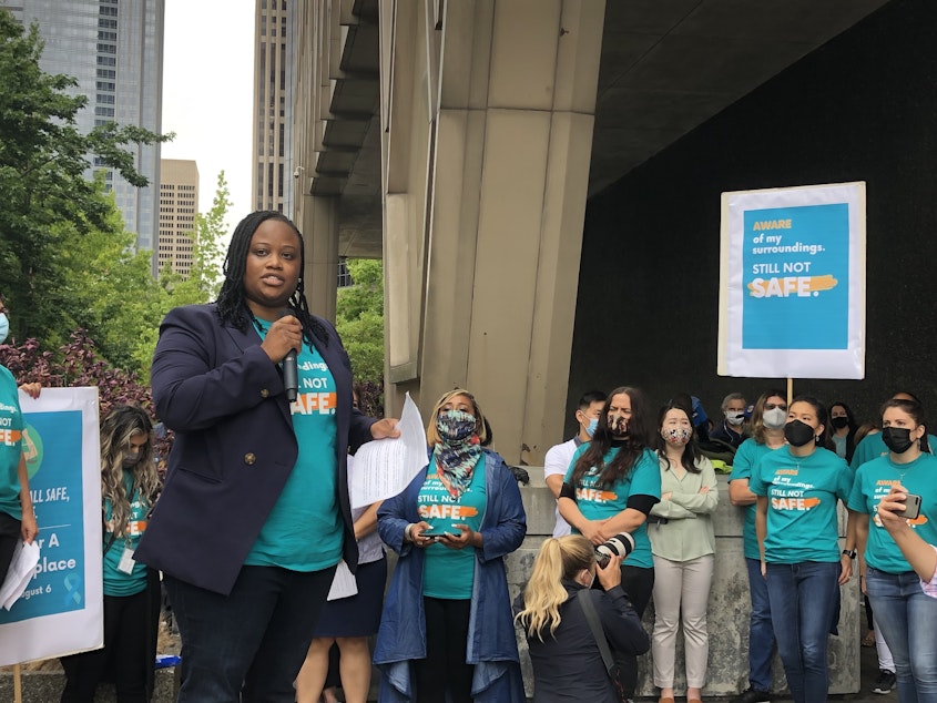 caption: King County Deputy Prosecuting Attorney Darrah Hinton said Friday's rally at the King County Courthouse was about workplace safety — not about blaming people in a nearby encampment.