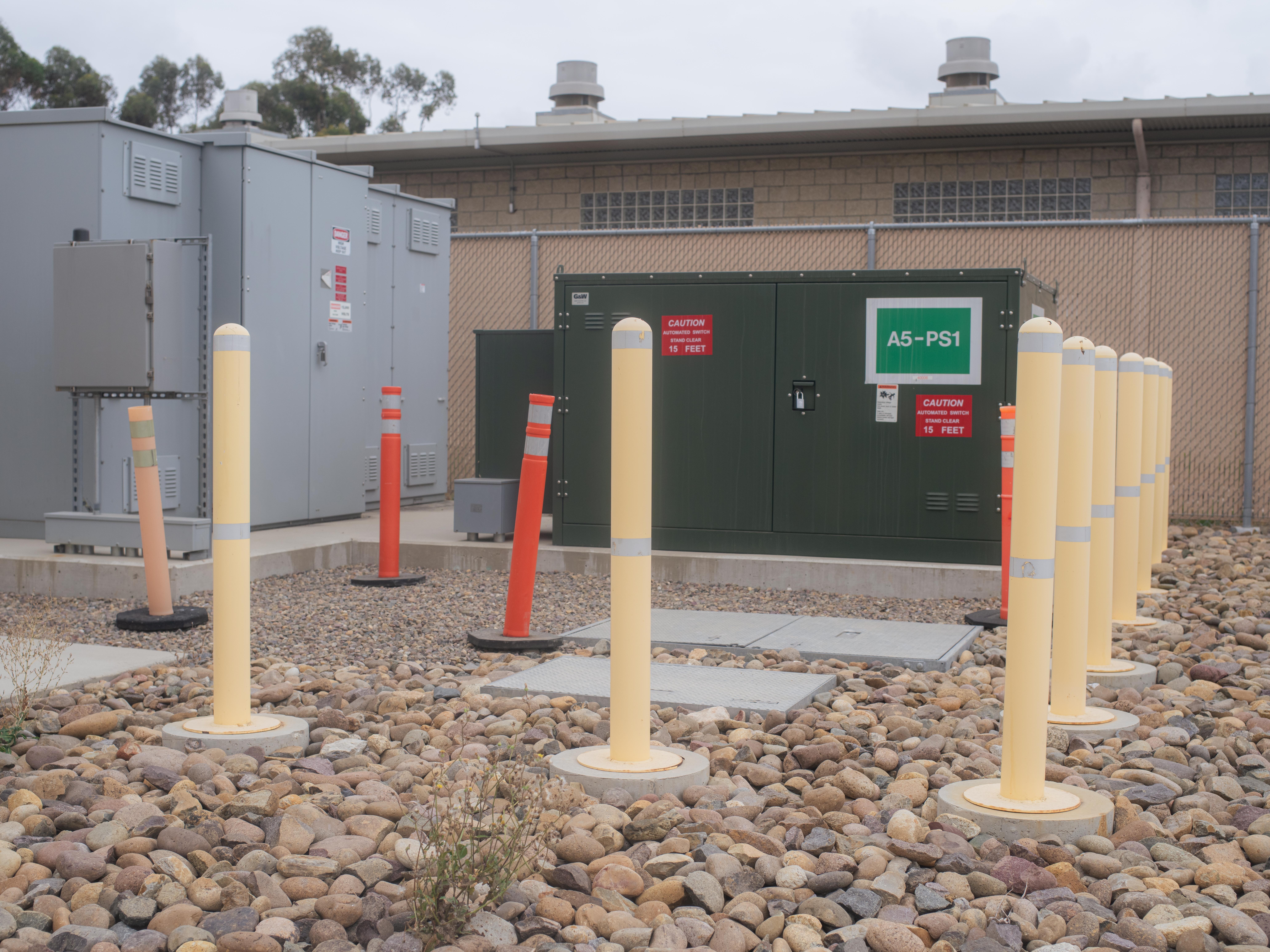 caption: Exterior of MCAS Miramar microgrid rooms in San Diego, California.