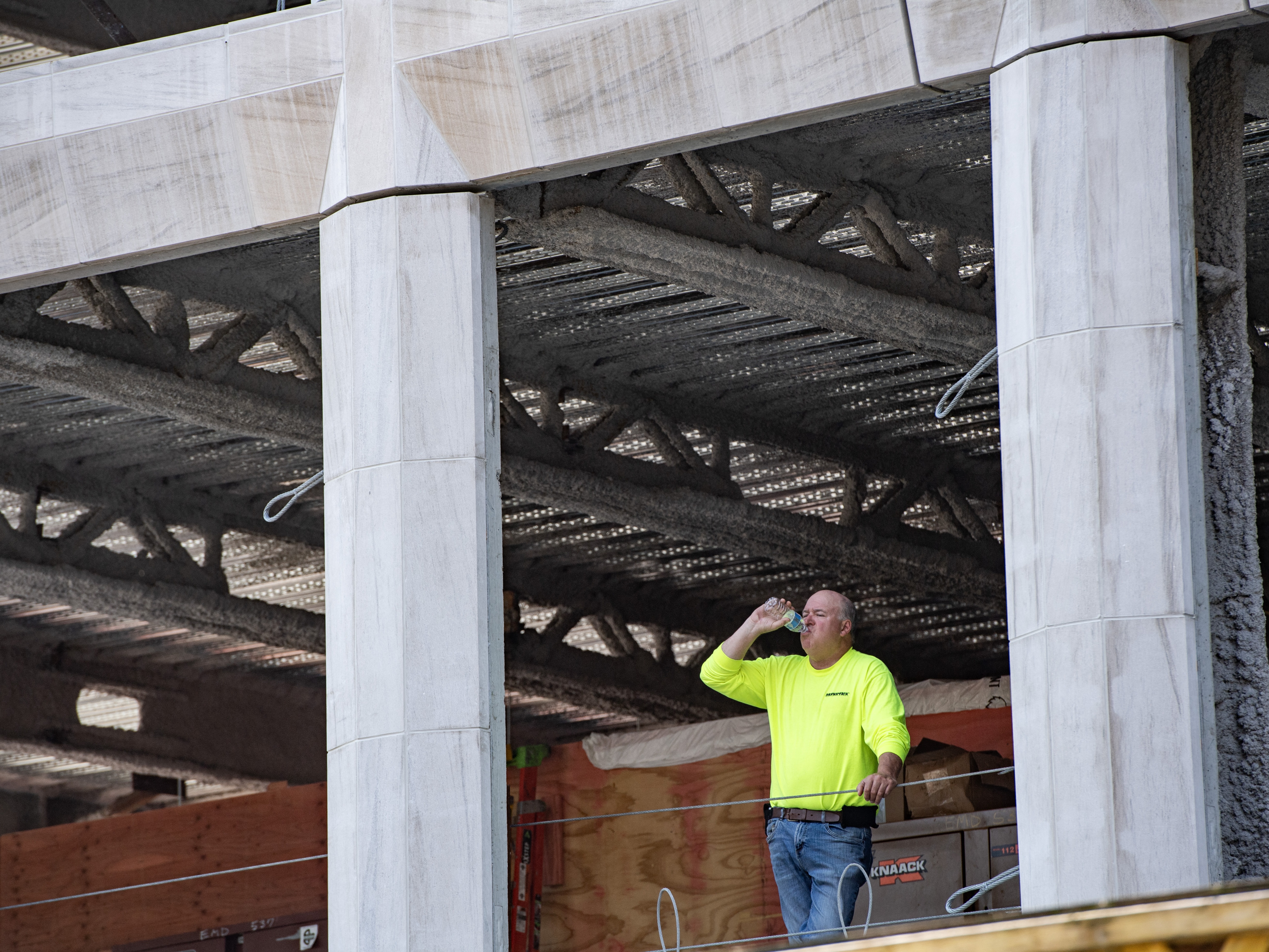 caption: A proposed rule from the the Occupational Safety and Health Administration would for the first time set in place regulations to better protect workers from extreme heat. Above,  a construction worker takes a break and drinks some water during a heatwave in Boston on June 19.