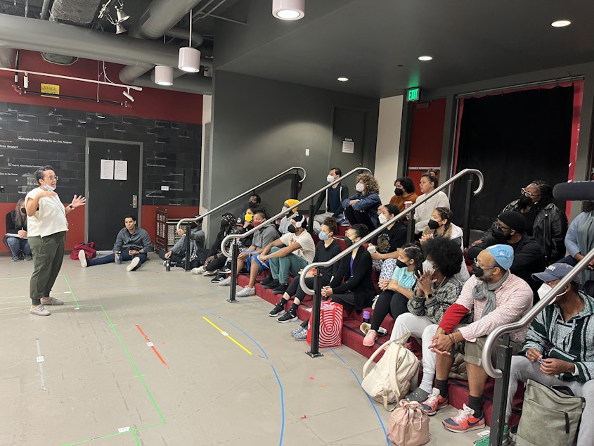 caption: Director and choreographer Kelly Foster Warder talks to the cast of The Wiz at rehearsal