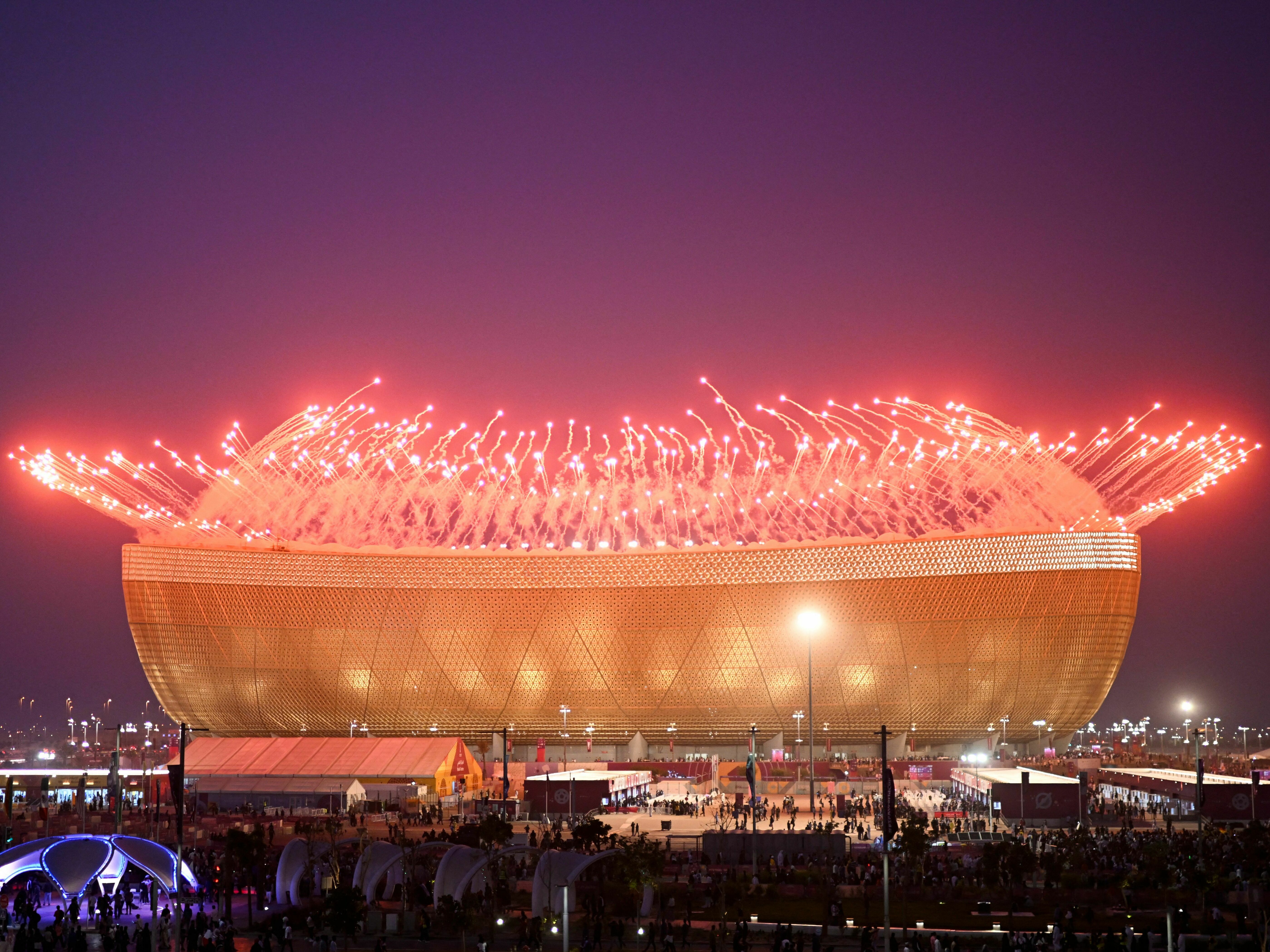 caption: Fireworks are pictured before the start of the Qatar 2022 World Cup final match between Argentina and France at Lusail Stadium north of Doha on December 18, 2022.