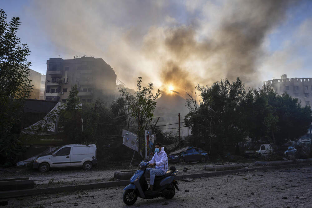 caption: Smoke rises from the site of an Israeli airstrike in Dahiyeh, Beirut, Lebanon. (Hassan Ammar/AP)
