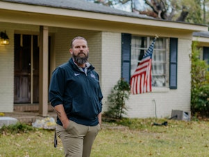 caption: Former Marine Jason Miles stands in front of his home in Clinton, Miss. He lost a sales job during the pandemic and had to take a forbearance.