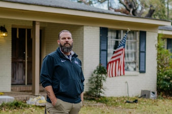 caption: Former Marine Jason Miles stands in front of his home in Clinton, Miss. He lost a sales job during the pandemic and had to take a forbearance.