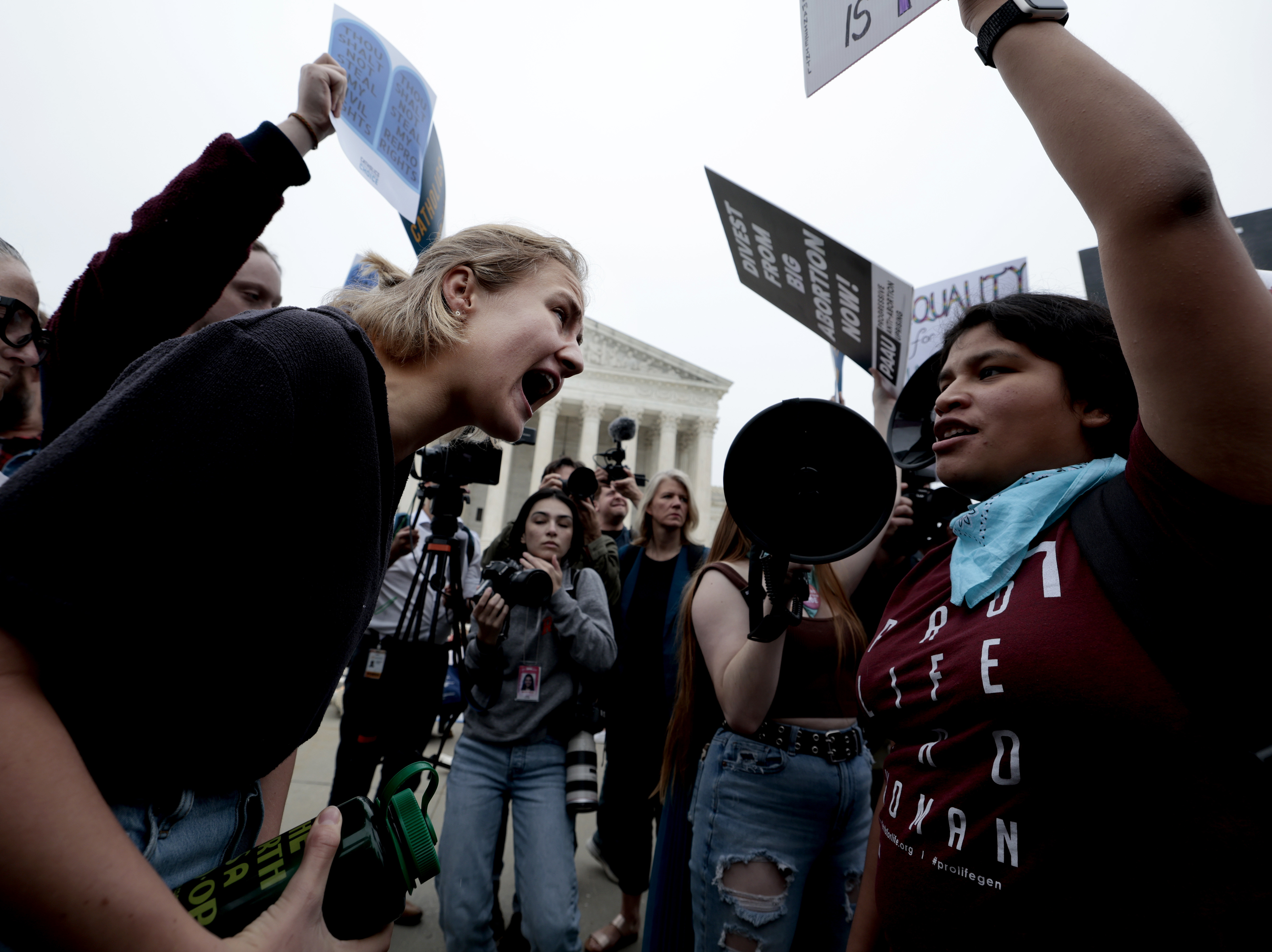 caption: Abortion rights and anti-abortion activists demonstrate in front of the Supreme Court on Tuesday.