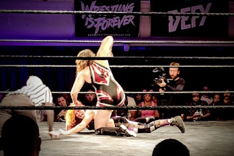 caption: Nicole Matthews takes on challenger Masha Slamovich at Defy Wrestling's "Violent Minds" event.