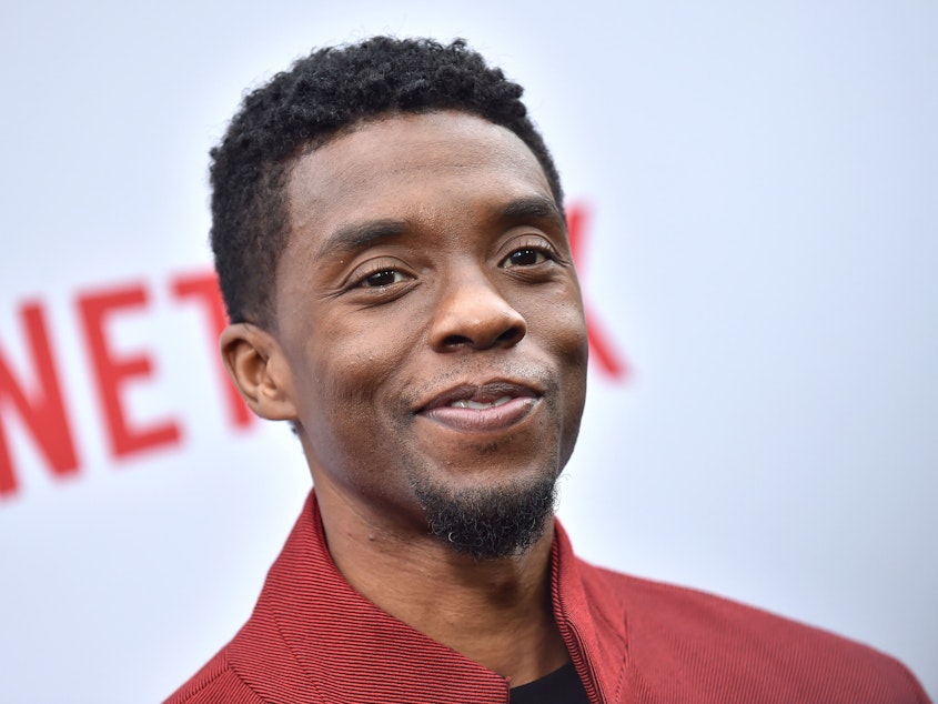 caption: Chadwick Boseman, pictured in June 2019 in Los Angeles, portrayed historical figures with dignity and humanity. In public comments, he gave thanks to those who came before him.