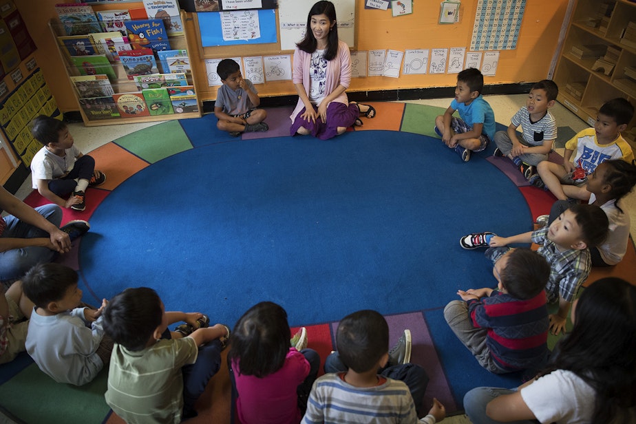 caption: Seattle Preschool Program teacher Hien Do, center, sits in a circle with her students on Wednesday, June 28, 2017, at the ReWA Early Learning Center at Beacon, in Seattle.